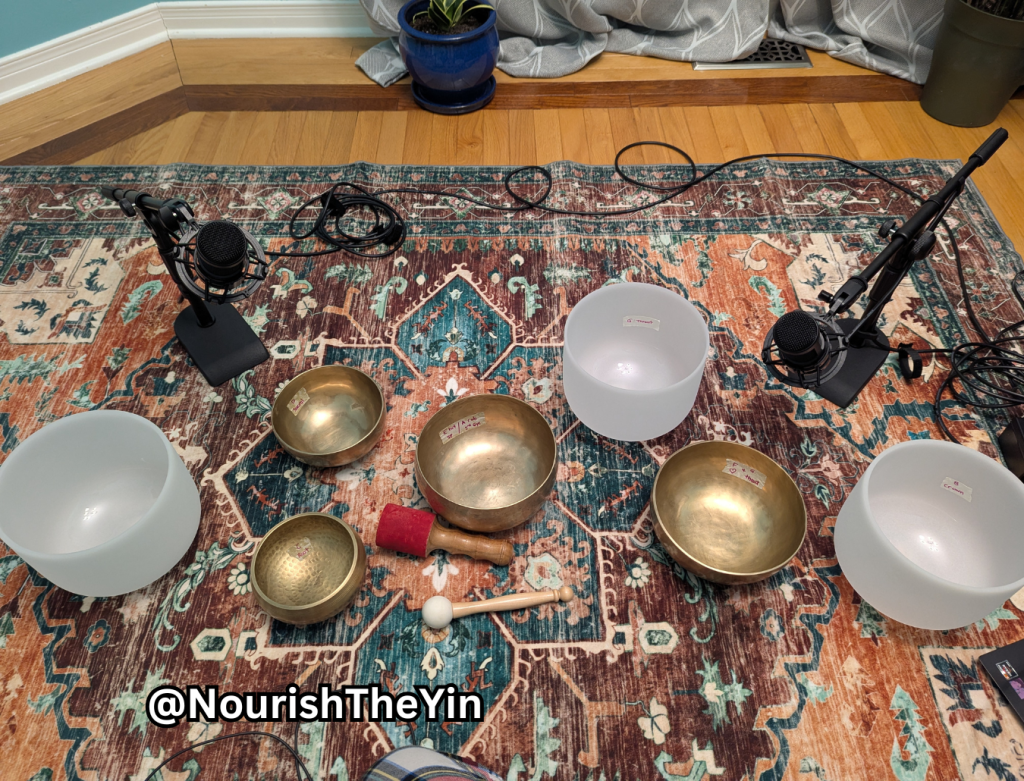 sound therapy equipment setup with sound bowls, mics, and cables on a carpet